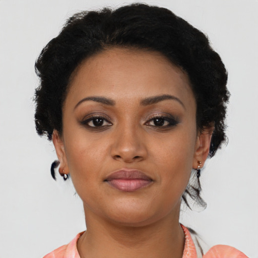 Joyful latino young-adult female with short  brown hair and brown eyes