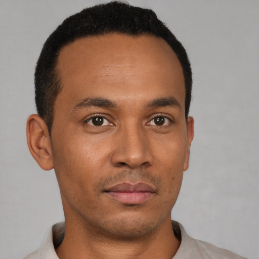 Neutral latino young-adult male with short  brown hair and brown eyes