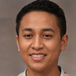 Joyful latino young-adult male with short  brown hair and brown eyes