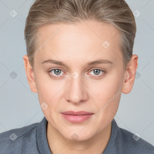 Joyful white young-adult female with short  brown hair and blue eyes