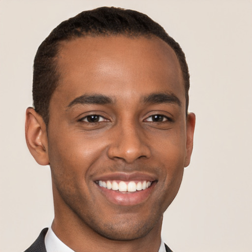 Joyful black young-adult male with short  brown hair and brown eyes