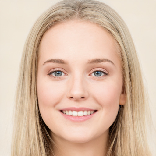 Joyful white young-adult female with long  brown hair and blue eyes