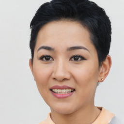 Joyful asian young-adult female with short  black hair and brown eyes