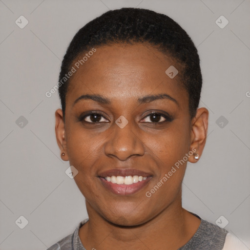 Joyful black young-adult female with short  black hair and brown eyes