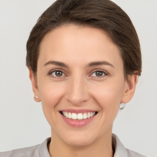 Joyful white young-adult female with short  brown hair and brown eyes