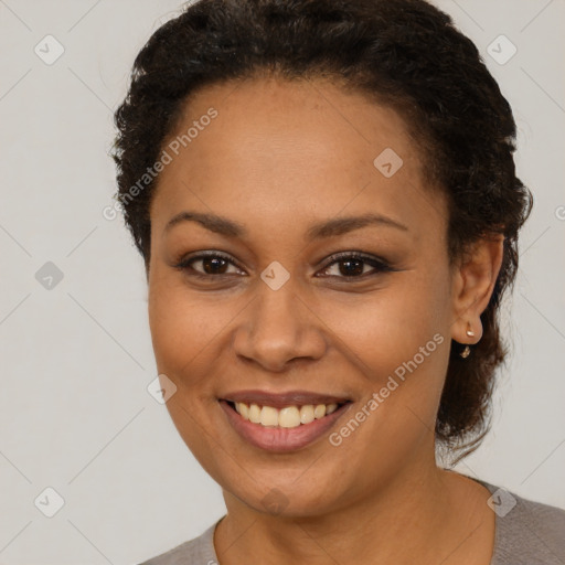 Joyful black young-adult female with short  brown hair and brown eyes