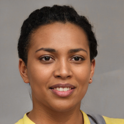 Joyful latino young-adult female with short  brown hair and brown eyes