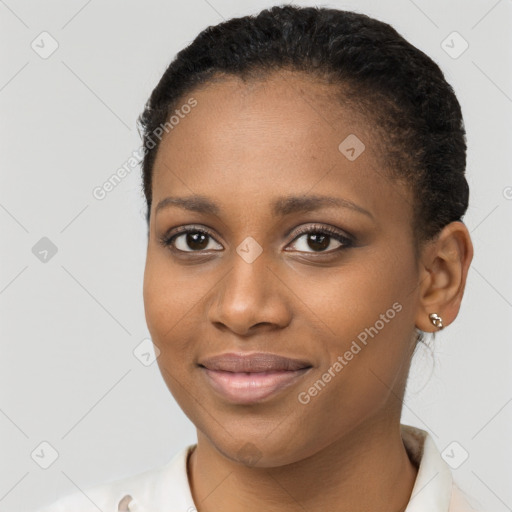 Joyful black young-adult female with short  brown hair and brown eyes