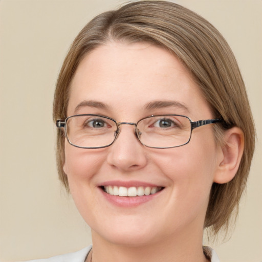 Joyful white adult female with medium  brown hair and green eyes