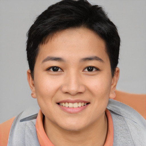 Joyful asian young-adult female with short  brown hair and brown eyes