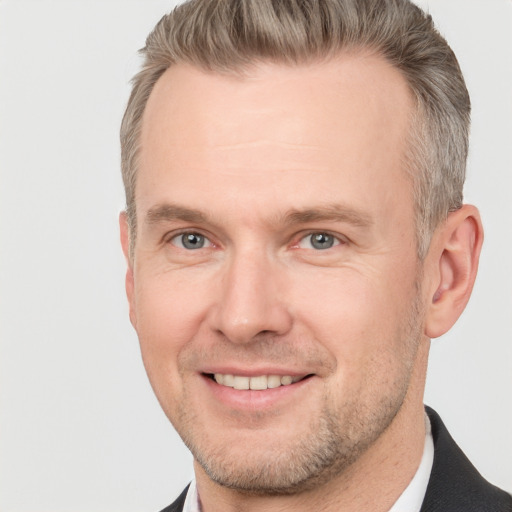 Joyful white adult male with short  brown hair and grey eyes