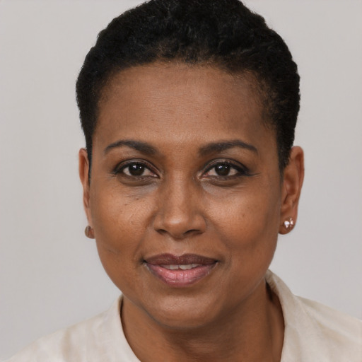 Joyful black adult female with short  black hair and brown eyes