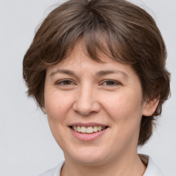 Joyful white adult female with medium  brown hair and brown eyes