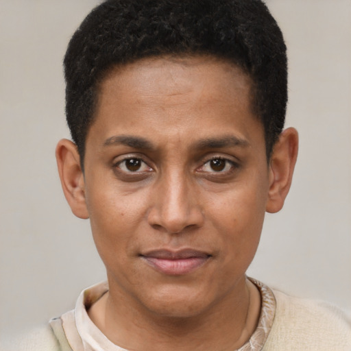 Joyful black young-adult female with short  brown hair and brown eyes