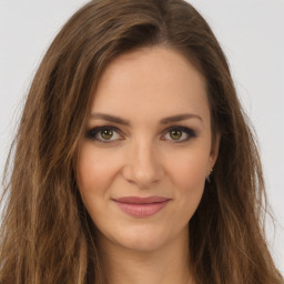 Joyful white young-adult female with long  brown hair and green eyes