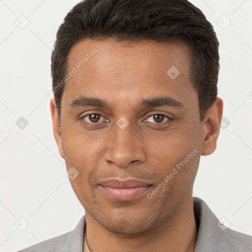 Joyful black young-adult male with short  brown hair and brown eyes