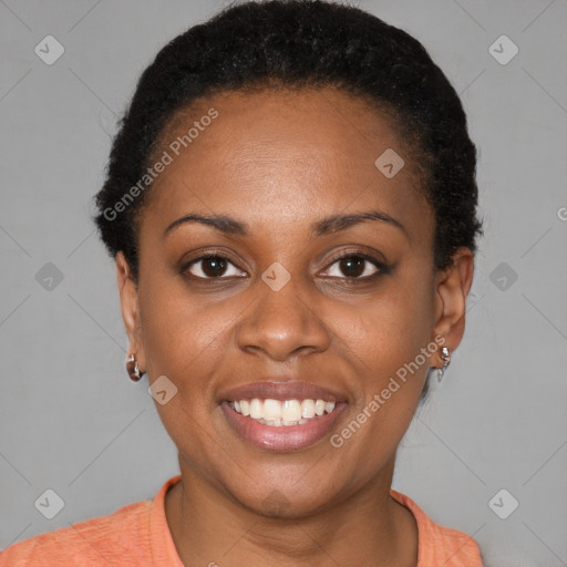 Joyful black young-adult female with short  black hair and brown eyes