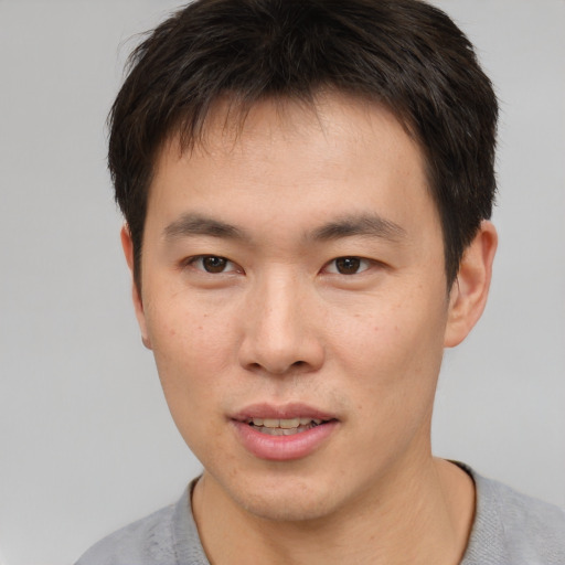 Neutral asian young-adult male with short  brown hair and brown eyes