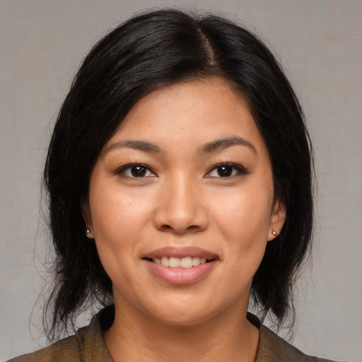Joyful asian young-adult female with medium  black hair and brown eyes