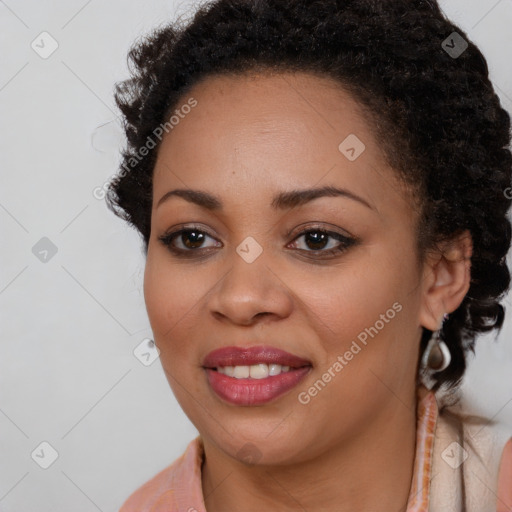 Joyful black young-adult female with long  brown hair and brown eyes