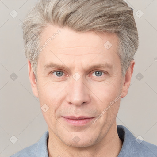 Joyful white adult male with short  brown hair and grey eyes