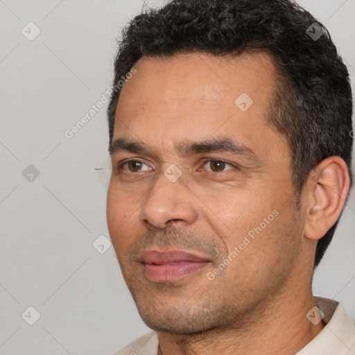 Joyful white adult male with short  black hair and brown eyes