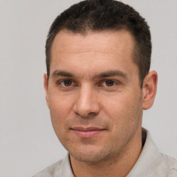 Joyful white adult male with short  brown hair and brown eyes