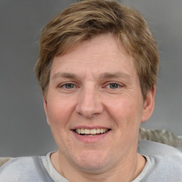 Joyful white adult male with short  brown hair and grey eyes