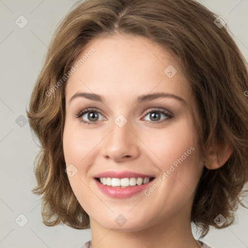 Joyful white young-adult female with medium  brown hair and green eyes