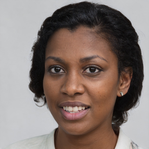 Joyful black young-adult female with medium  brown hair and brown eyes