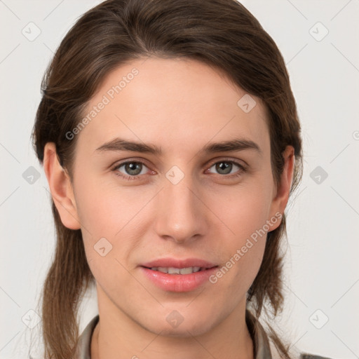 Joyful white young-adult female with medium  brown hair and grey eyes