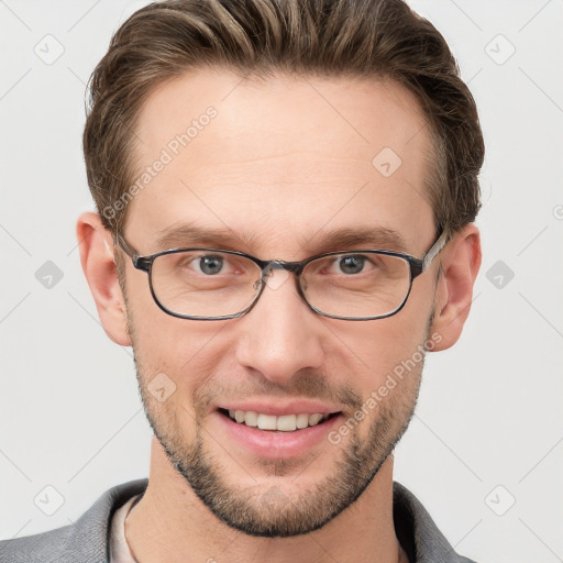 Joyful white young-adult male with short  brown hair and grey eyes