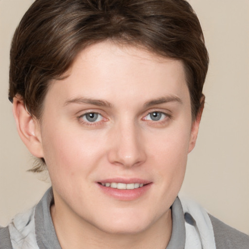 Joyful white young-adult female with short  brown hair and grey eyes