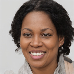 Joyful black adult female with medium  brown hair and brown eyes