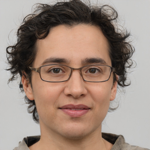 Joyful white adult male with medium  brown hair and brown eyes