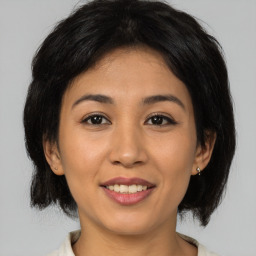 Joyful asian young-adult female with medium  brown hair and brown eyes