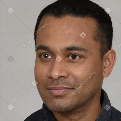 Joyful latino young-adult male with short  black hair and brown eyes