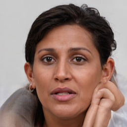 Joyful white adult female with short  brown hair and brown eyes