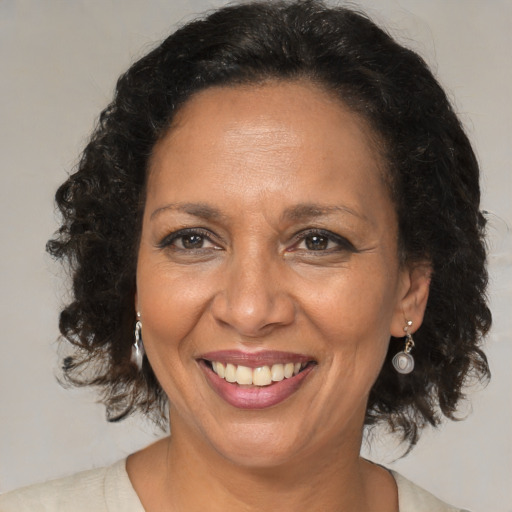 Joyful black adult female with medium  brown hair and brown eyes