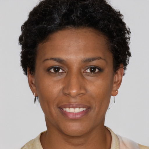 Joyful black young-adult female with short  brown hair and brown eyes