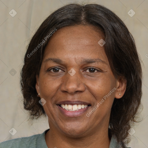 Joyful black adult female with medium  brown hair and brown eyes