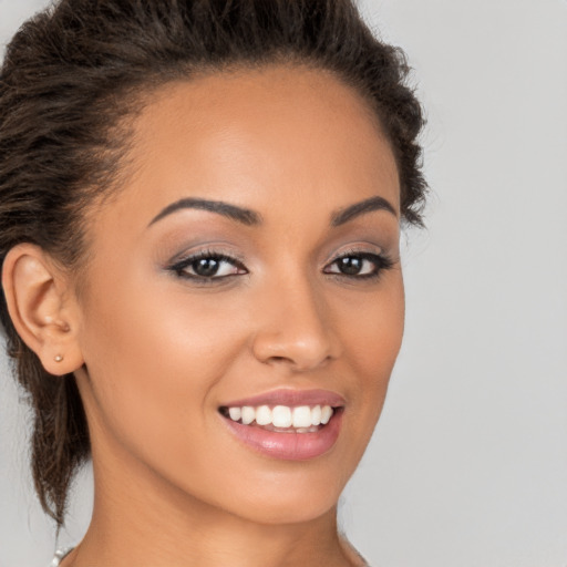 Joyful latino young-adult female with long  brown hair and brown eyes