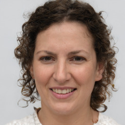 Joyful white young-adult female with medium  brown hair and green eyes