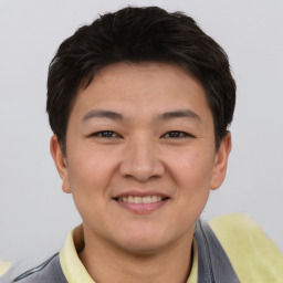 Joyful asian young-adult male with short  brown hair and brown eyes