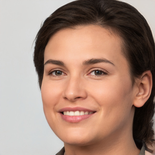 Joyful white young-adult female with medium  brown hair and brown eyes