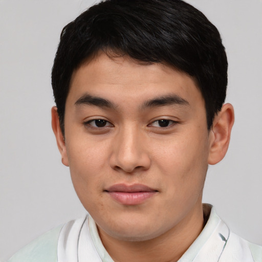 Joyful asian young-adult male with short  brown hair and brown eyes