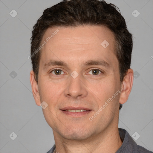 Joyful white adult male with short  brown hair and grey eyes