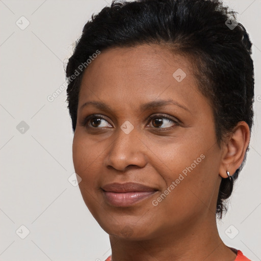 Joyful black adult female with short  brown hair and brown eyes