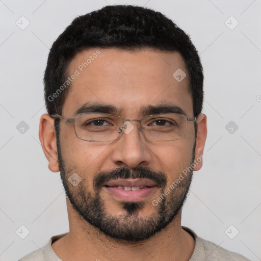 Joyful white young-adult male with short  black hair and brown eyes