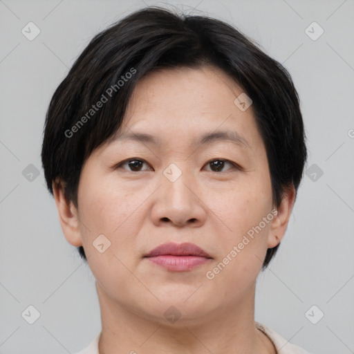 Joyful asian adult female with short  brown hair and brown eyes